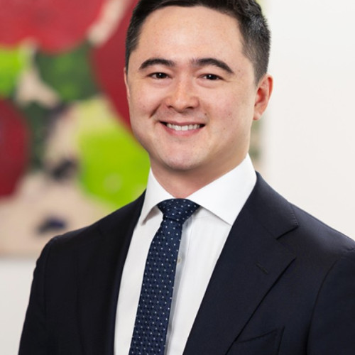 Paul Greaves - Smiling headshot in a suit and tie